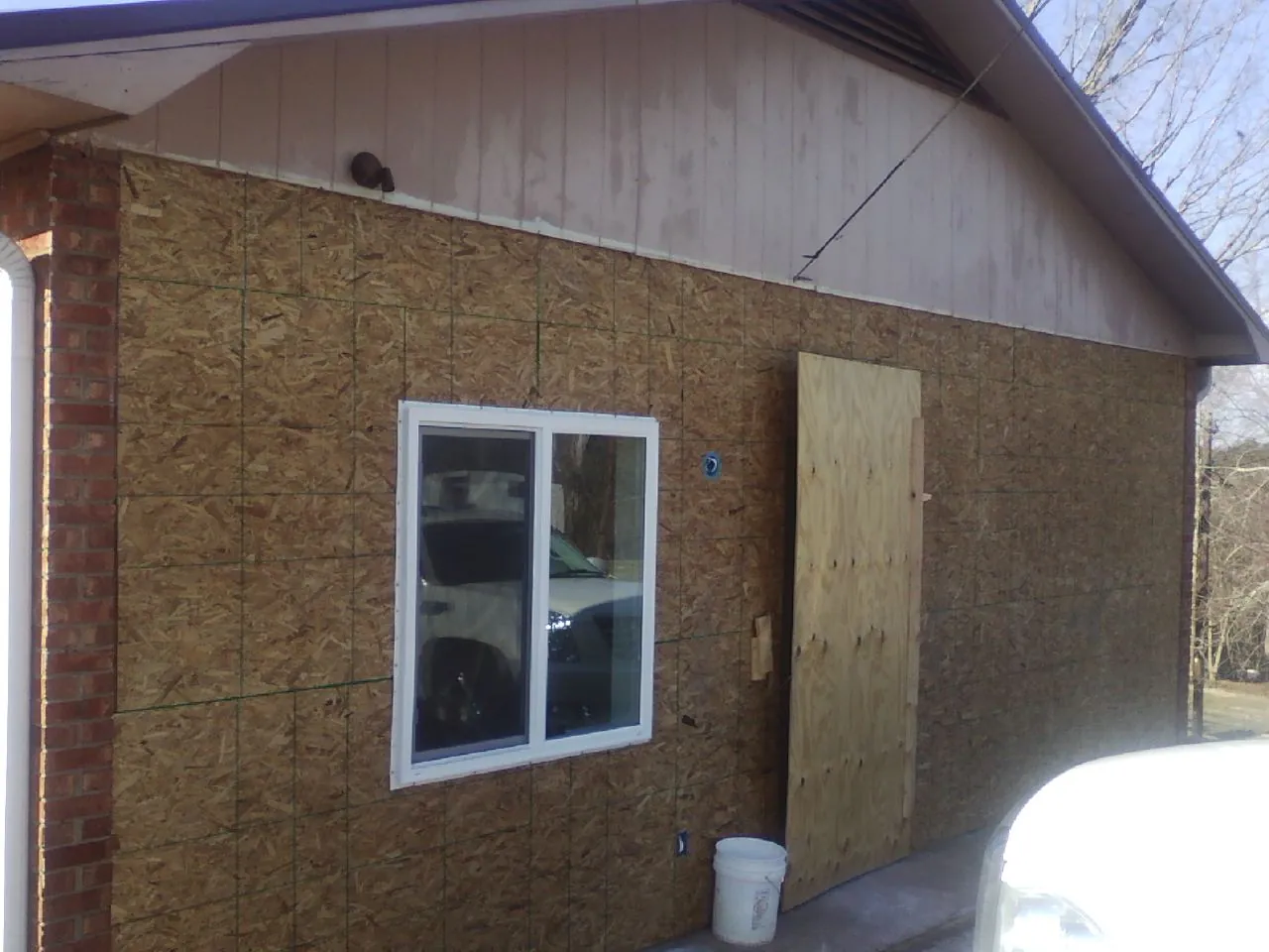 OSB sheathing on a garage addition wall before siding in Heppner
